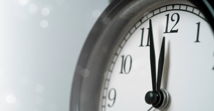 Close up clock approaching midnight represents countdown deadline, urgency and time passing with copy space for New Year, business planning, time management, schedule and last minute concepts.