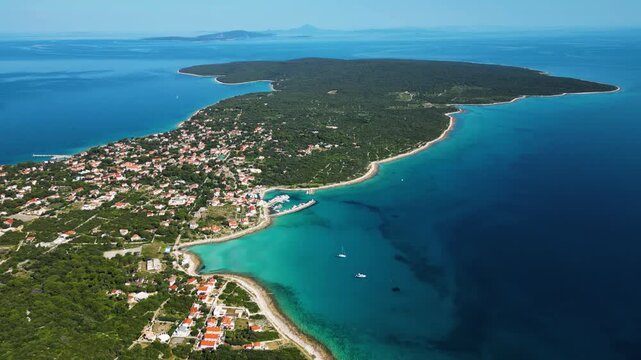 Aerial drone panorama of Silba Island, Croatia, surrounded by the crystal-clear Adriatic Sea. The picturesque coastal village, turquoise shoreline and Mediterranean vegetation showcase the beauty of