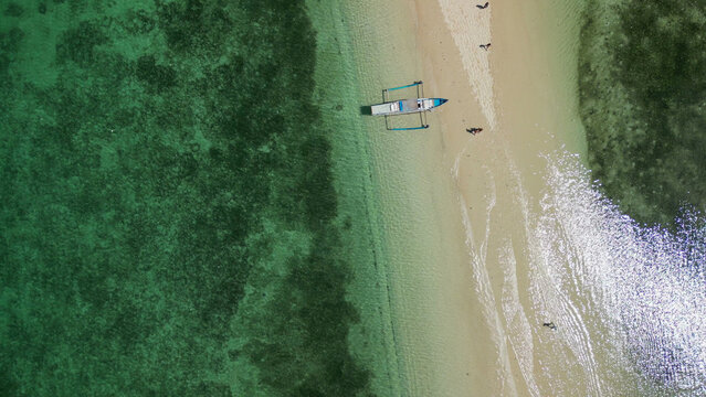 Aerial drone view Gili Kere Sand Tongue Lombok Indonesia on sunny day with white sandbar turquoise lagoon and tropical seascape