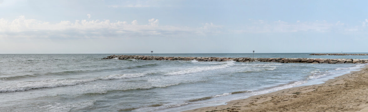 stone groin on Adriatic sandy beach , Eraclea Mare, Italy