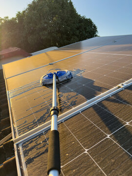 Start washing dirty solar panels with brush