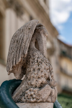Weathered stone pelican sculpture on the Batthyany Lajos monument railing in a residential district of Budapest, Hungary