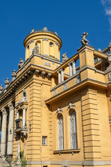 Corner tower with statues and a balcony lamp on the Széchenyi bath house facade in Budapest, Hungary © Guillaume Angleraud