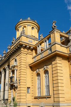Corner tower with statues and a balcony lamp on the Sz&eacute;chenyi bath house facade in Budapest, Hungary