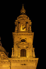 Clock face and shuttered belfry windows illuminate the bell tower of St Stephen's Basilica in Budapest, Hungary © Guillaume Angleraud