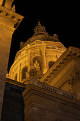 Statue niche and neoclassical dome rise between stone cornices at St Stephen's Basilica in Budapest, Hungary © Guillaume Angleraud
