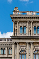 Corner of the Hungarian Academy of Sciences with a winged sculpture on the balustrade and Corinthian columns in Budapest, Hungary © Guillaume Angleraud