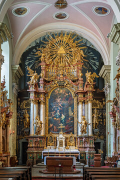 Baroque high altar with an altarpiece, gilded angels and a sunburst in the Servite Church of Pest in Budapest, Hungary
