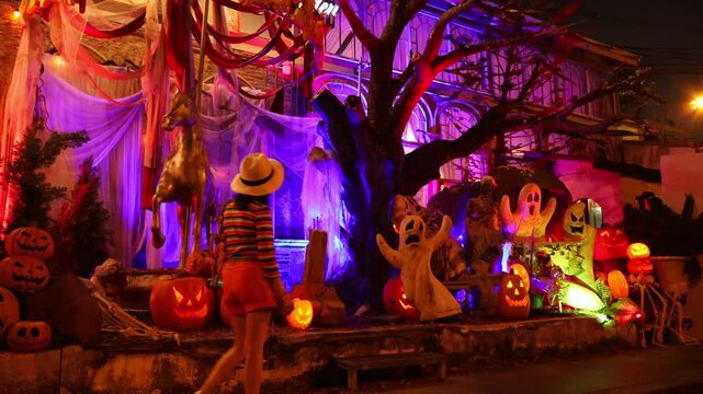 Footage of a female visitor wandering through an eye-catching lit Halloween outdoor event