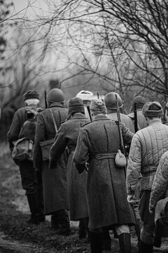 World War II Russian Soviet Red Army Soldiers Marching Through Forest. Soldier Of WWII WW2 Times