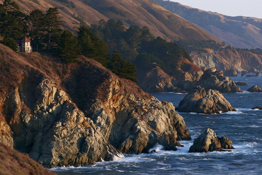 Serene Coastal Cliffside Teahouse Overlooking Crystal-Clear Ocean Waves at Sunset