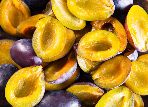 Plums on wooden background