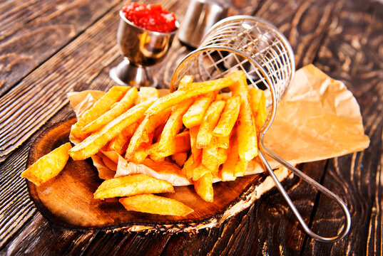 Crisp golden brown curly fried potato with rich red tomato dipping sauce close-up for snack or appetizer