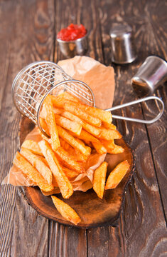 Crisp golden brown curly fried potato with rich red tomato dipping sauce close-up for snack or appetizer