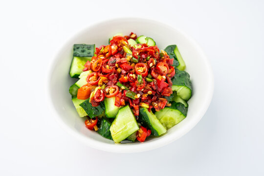 A plate of cold cucumber salad with a sour and spicy dressing