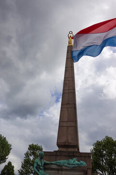 The G&euml;lle Frau war memorial on Place de la Constitution in Luxembourg City, featuring a tall granite obelisk topped with the famous gilded bronze statue of the Lady of Freedom.