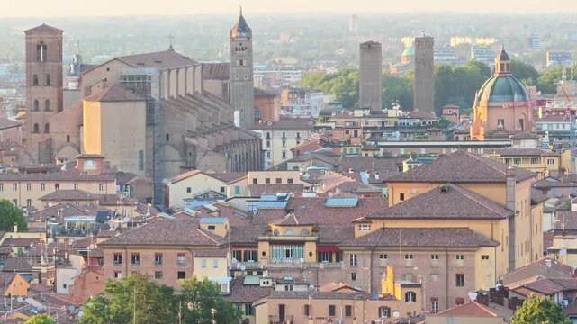 Bologna cityscape and skyline featuring the iconic medieval Asinelli Tower and Garisenda Tower, in historic buildings and terracotta rooftops in Italy with Basilica Saint Petronius patron of Bologna