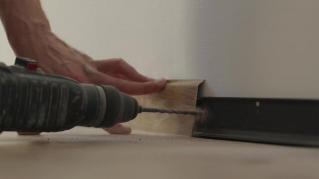Close up of drill bit boring hole into concrete wall