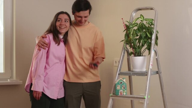 Couple celebrating new home purchase as man tosses keys