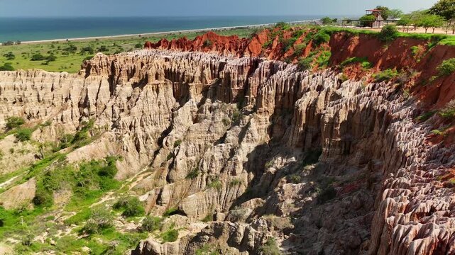 Panoramic aerial view of Miradouro da Lua featuring dramatic eroded rock formations, sharp clay spires, and striking red soil cliffs overlooking coastal landscape in Luanda Angola.