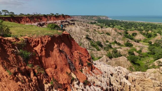 Panoramic aerial view of Miradouro da Lua featuring dramatic eroded rock formations, sharp clay spires, and striking red soil cliffs overlooking coastal landscape in Luanda Angola.