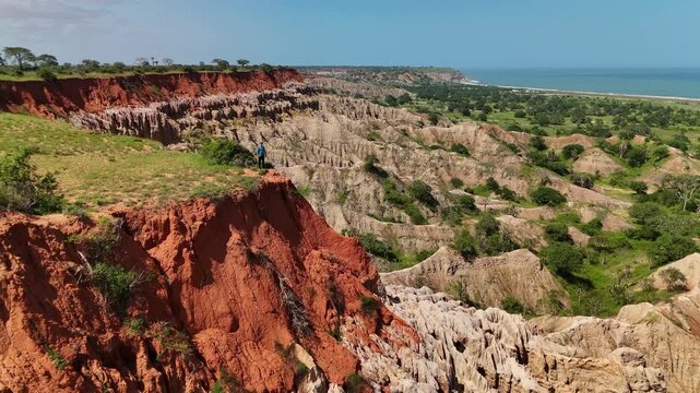 Panoramic aerial view of Miradouro da Lua featuring dramatic eroded rock formations, sharp clay spires, and striking red soil cliffs overlooking coastal landscape in Luanda Angola.