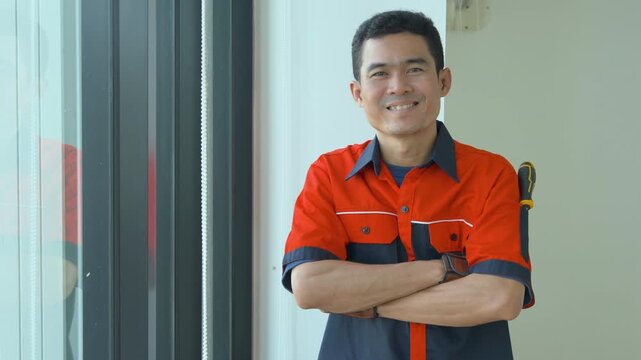 Portrait of a smiling construction worker wearing an orange hard hat and safety uniform