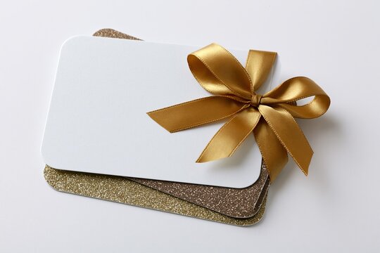 The Gift Card Stack with Golden Ribbon Bow on White Cards