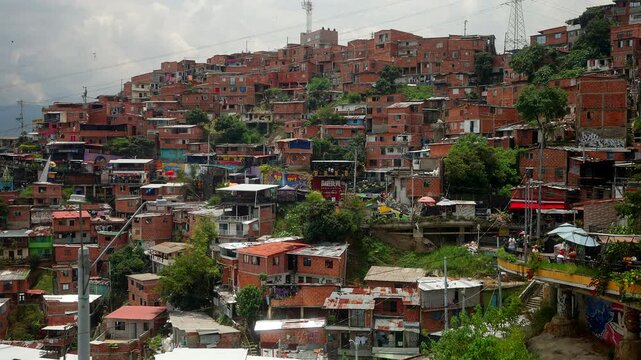 Dense Red Brick Houses Built Along The Steep Hillsides Of Comuna 13 District In Medell&iacute;n, Colombia. - wide shot