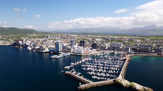 Bodo coastal city harbour and waterfront with lots of docked vessels. Drone view