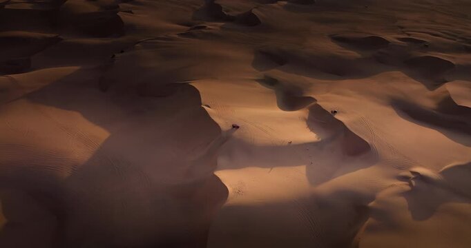 Dune buggy ecotourism tours in Huacachina desert at sunset, aerial view