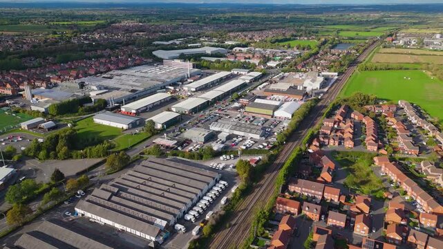 Wide aerial view of industrial zone and railway line near town