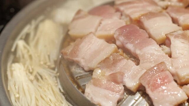 Raw Pork Belly and Enoki Mushroom Grilled with Onion on Korean Tabletop Grill