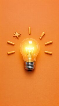 Glowing Lightbulb on Textured Orange Background with Idea Symbols