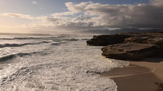 massive wave sets rolling into shore, Walker Bay Nature Reserve, South Africa at sunset