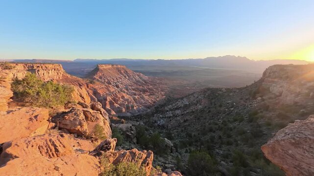 Watch as the sun rises over Zion National Park from Gooseberry Mesa in Utah. Experience the beauty of this natural landscape.