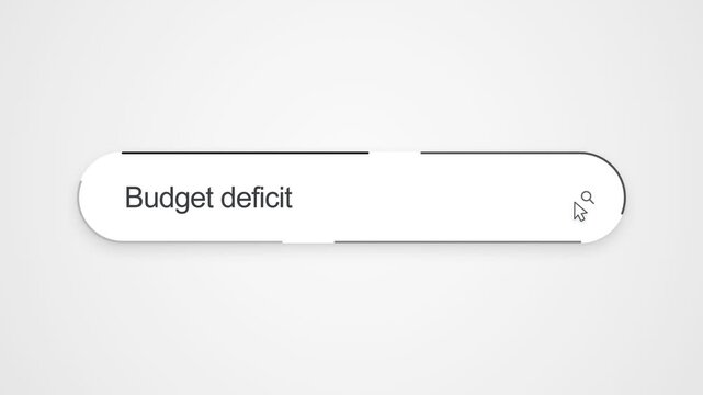 Close-up view of typing &ldquo;Budget deficit&rdquo; into an online search bar with a cursor positioned near the search icon, illustrating financial research and economic information