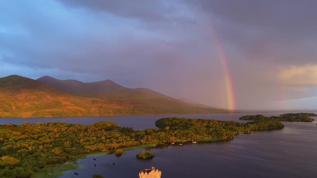 Sunrise in Killarney national park, Ireland, aerial view of lake and medieval castle in Ireland, travel in Ireland, historic Ross castle drone shot