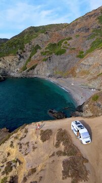 La Frana Beach in Sardinia, Italy offers stunning coastal views with turquoise waters and rocky cliffs. Perfect for relaxation and enjoying the serene Mediterranean environment in a camper van