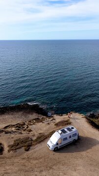 La Frana Beach in Sardinia, Italy, where the serene coastline meets crystal-clear waters. Experience the beauty of this relaxing destination perfect for vacations and travel adventures in a camper van