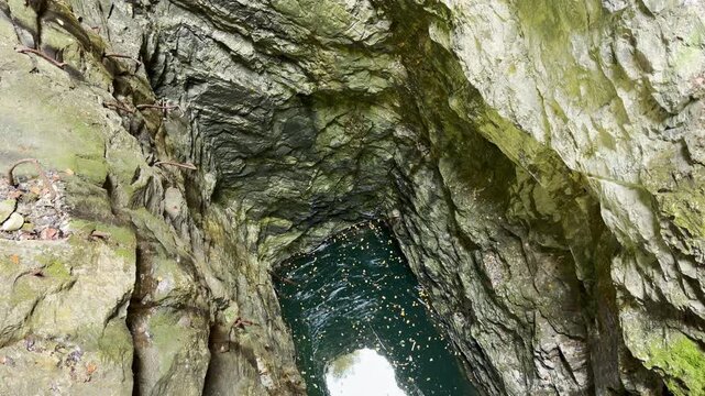 Dark water rests deep inside a steep rock shaft at Ruskeala, Karelia. Looking into the mysterious stone pit evokes thrill and wonder.