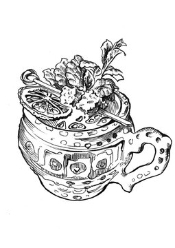 Tea og hot wine drink in rural clay cup with ornament, topped by lemon slice, mint and jelly decoration