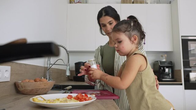 Mother and daughter preparing a healthy meal in the kitchen