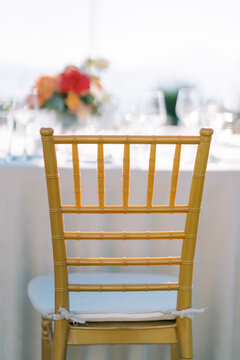 Elegant gold chair at wedding reception table