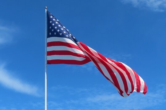 American flag fluttering on blue sky background
