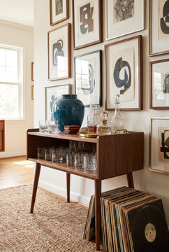 Sophisticated midcentury bar corner with walnut console, glass decanters and vinyl records