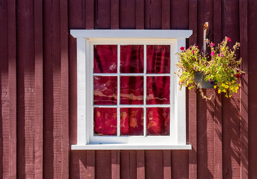 Traditional wooden facade with window and flowers, Telegraph Cove, Vancouver Island, Canada.