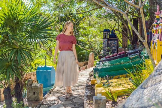 Woman tourist visiting traditional Mexican cemetery during Day of the Dead, walking among colorful graves and folk art in Mexico, cultural travel concept