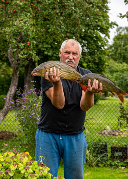 photo of an angler showing off his caught fish, fishing concept, carp fishing, healthy eating,