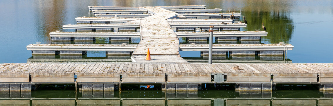 Beautiful Sparks Marina Park, lake and neighborhood, in Reno, Nevada. Empty wooden floating boat dock